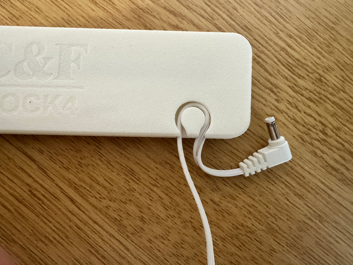 Built-in cord holder detail on a Clover & Fox Forge baby monitor screen dock