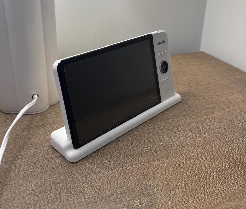 VTech Baby Monitor 7" Screen Dock | Cord Holder | RM7764HD & More on bedside table, showcasing stable design and cord management.