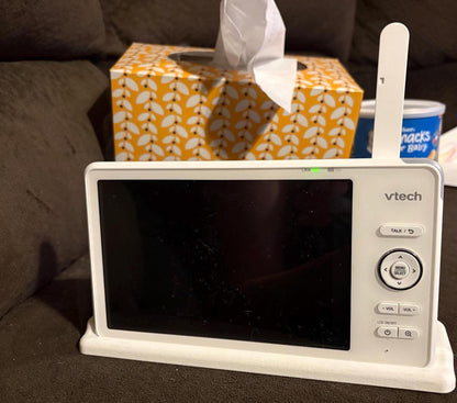VTech Baby Monitor 7" Screen Dock | Cord Holder | RM7766HD & RM7757HD on a couch with tissues in the background.