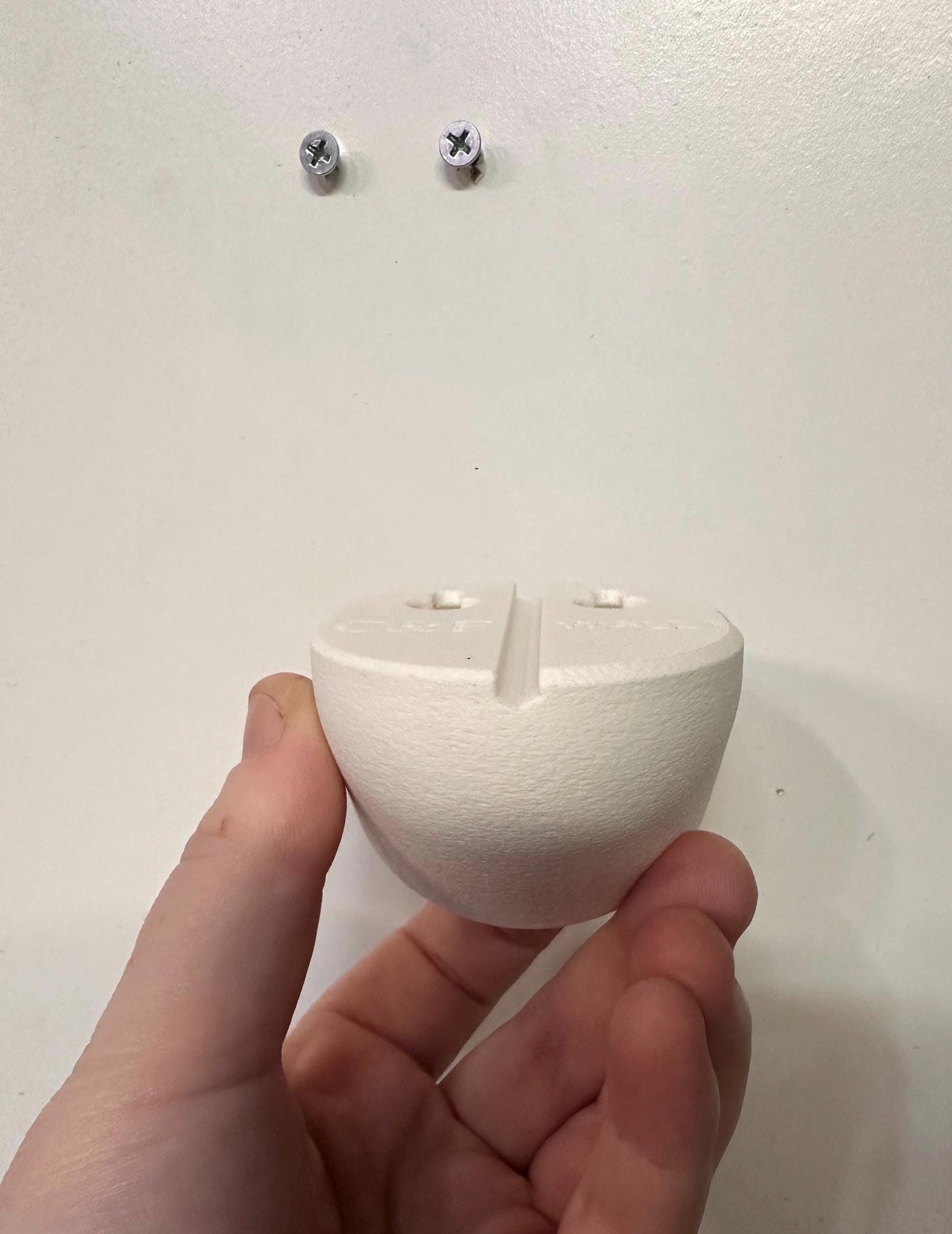 Eufy Baby Monitor Wall Mount | Angled | E210 in hand showing installation compatibility for baby monitor mount