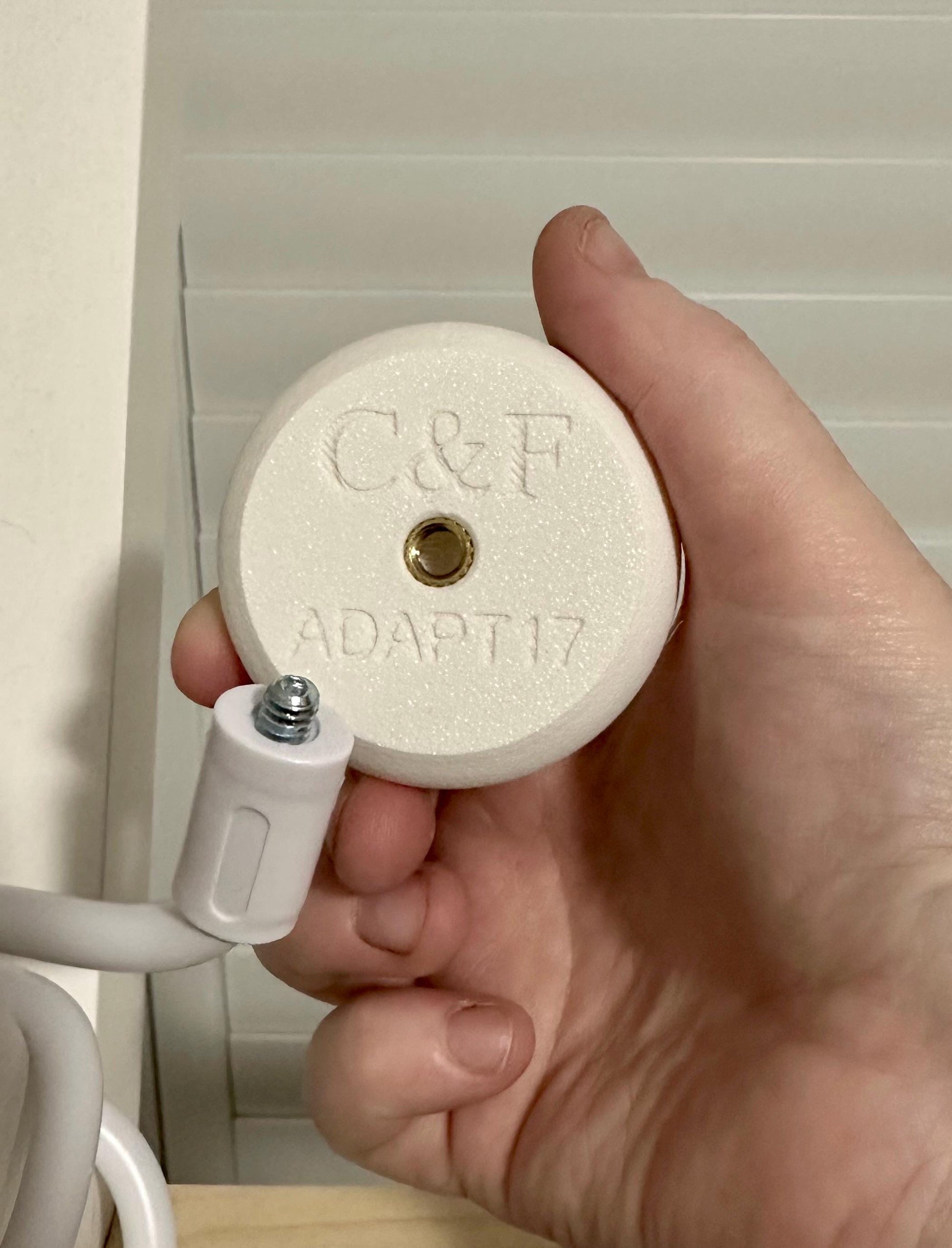 Eufy Baby Monitor Mount Adapter | E210 | 1/4" Thread in hand demonstrating its design for baby monitor mounting.