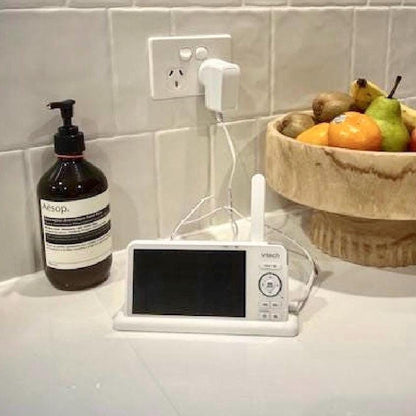 VTech Baby Monitor 5" Screen Dock | Cord Holder | RM5766HD & More placed beside a fruit bowl on a kitchen counter.