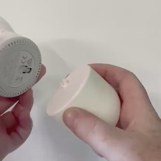close-up of hands holding the Eufy Baby Monitor Wall Mount | Angled | E210 for installation on the wall