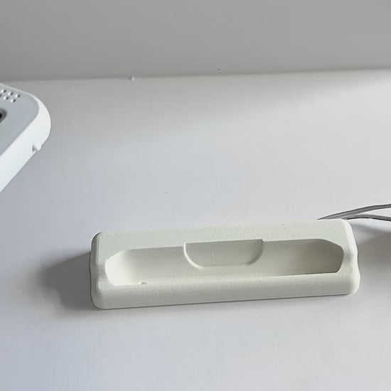 Oricom Baby Monitor Screen Dock | Cord Holder | SC875 on a flat surface with charging cable.