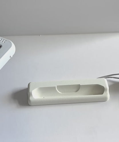 Oricom Baby Monitor Screen Dock | Cord Holder | SC875 on a flat surface with charging cable.