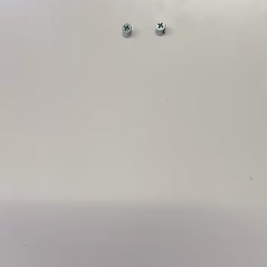 Mounted metal screws on a wall for Infant Optics Baby Monitor Wall Mount installation.