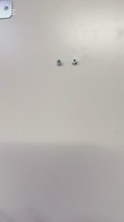 Mounted metal screws on a wall for Infant Optics Baby Monitor Wall Mount installation.